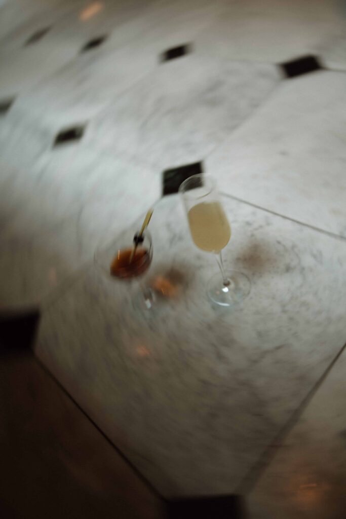 Cocktails on a checkered marble floor at Emery Hotel.