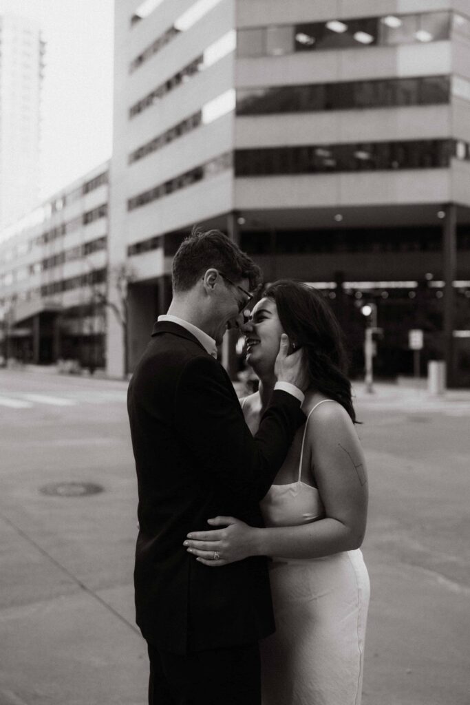 Couple hug each other outside one of the best engagement session locations in the twin cities.