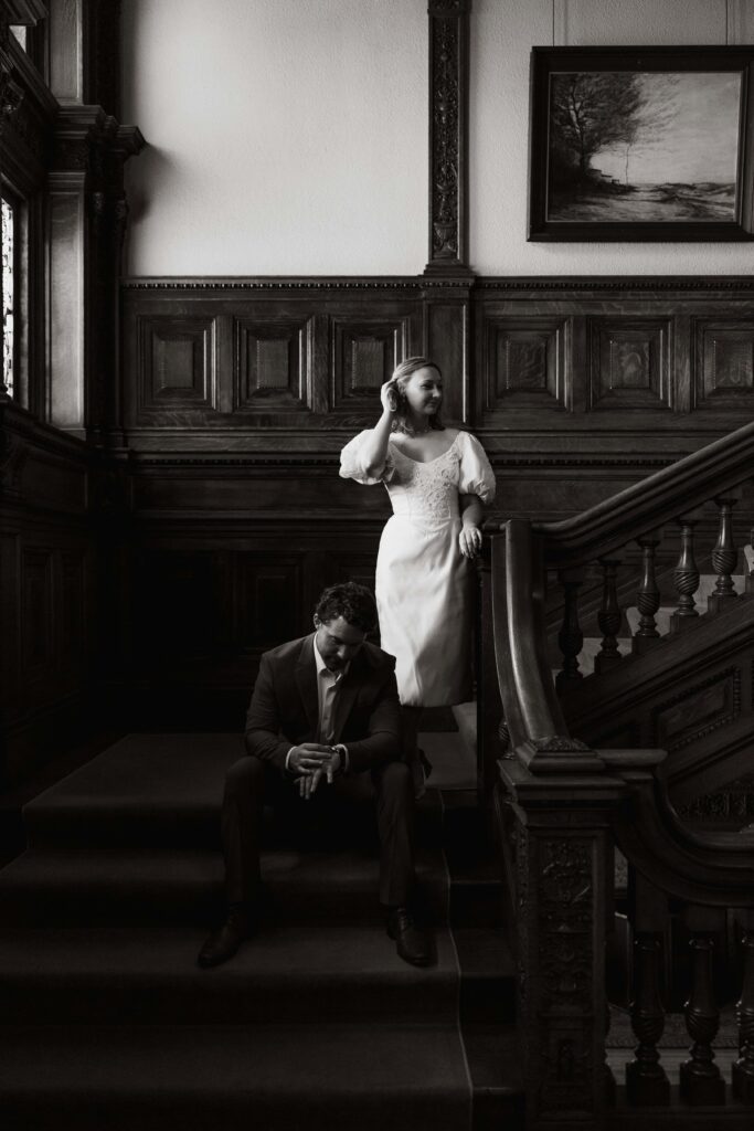 Engaged couple pose on a staircase at one of the best engagement session locations in the twin cities.