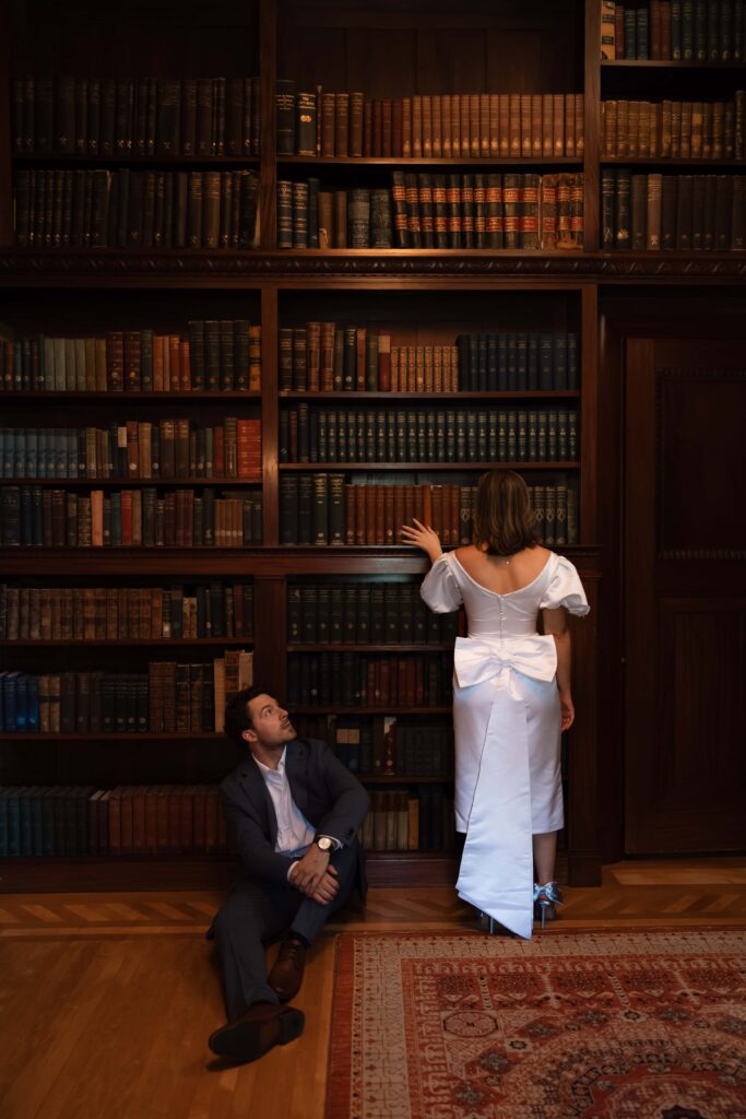 Editorial couple standing in a historic library.