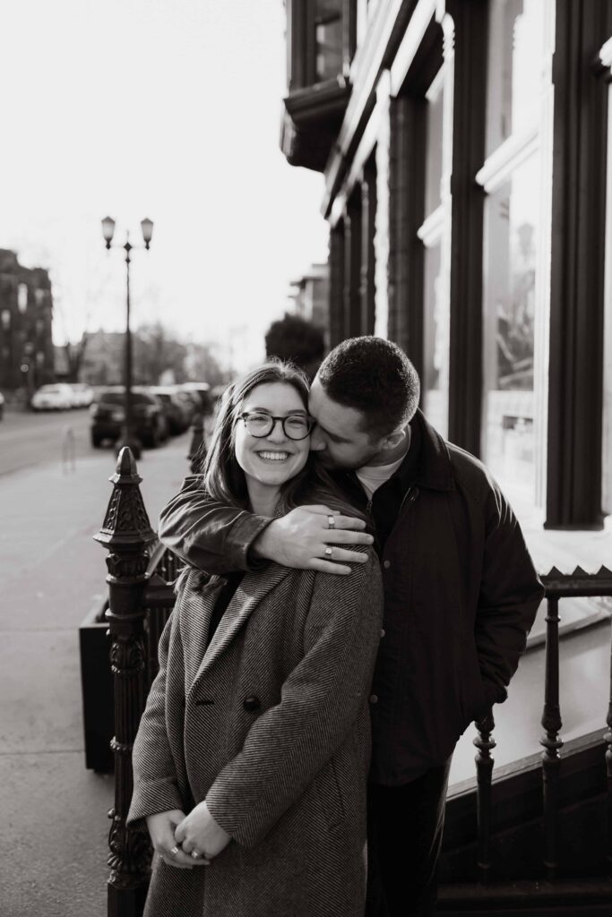 Engaged couple embrace during a romantic engagement session.