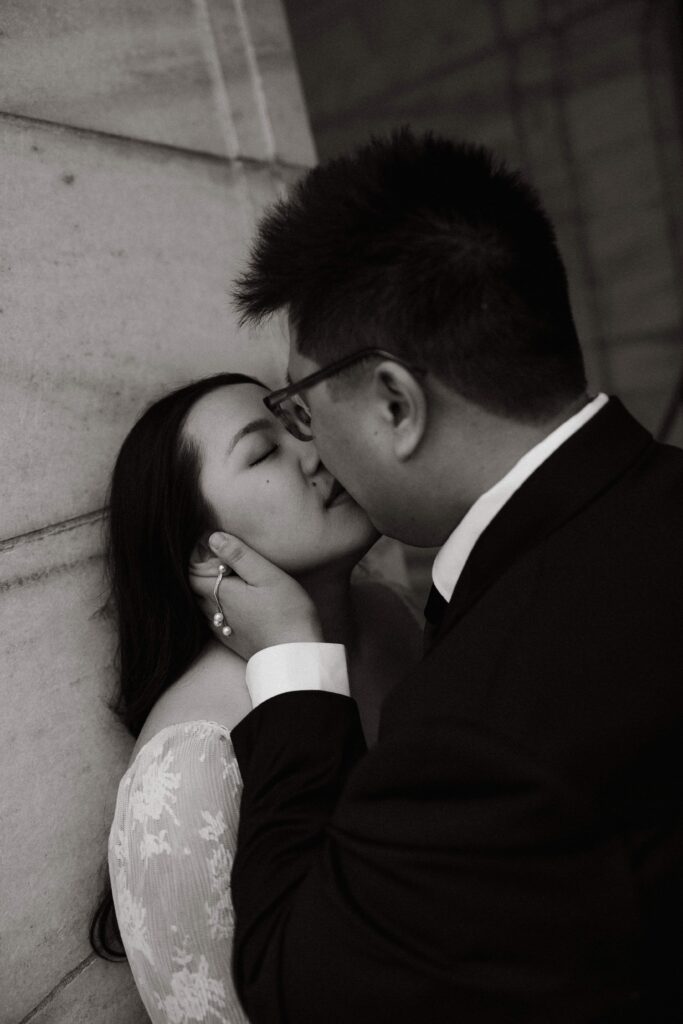 Romantic couple kiss in front of the St. Paul Capitol building.