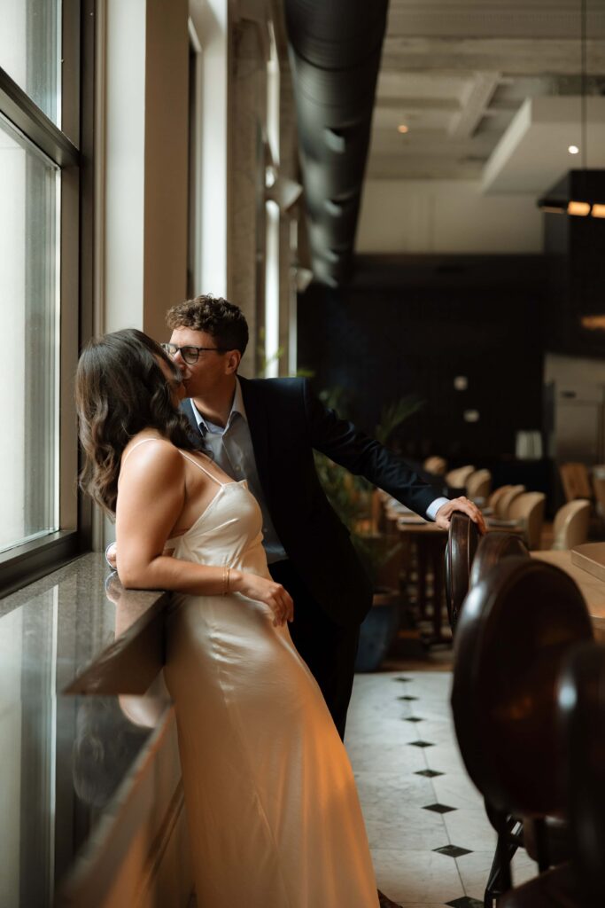 Couple kiss as they stand at a Guilia's bar in Minneapolis, Minnesota.