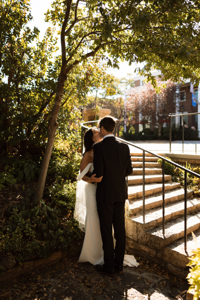 Bride and groom kiss at the secret garden in Stillwater, Minnesota.