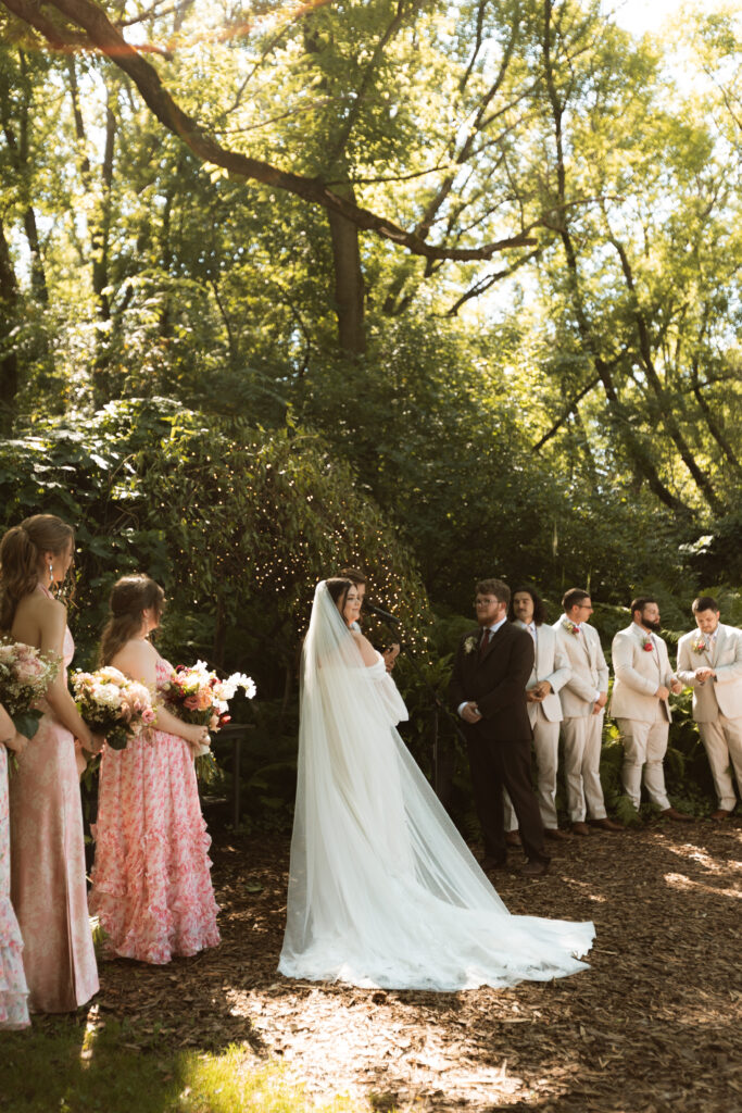 Bride looks out at her guests during the ceremony at Camrose Hill. 