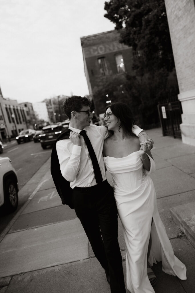 Bride and groom walk together in downtown Stillwater, Minnesota.