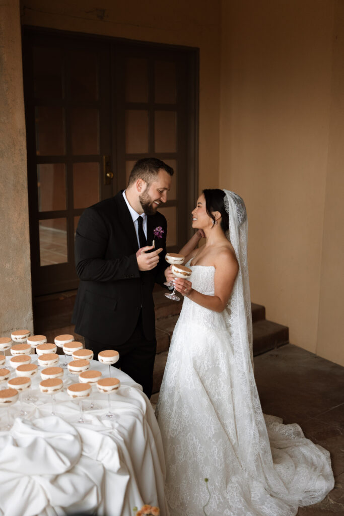 A bride and groom laughing together over tiramisu coupes at their Little Daisy Jerome wedding reception, captured in a candid documentary moment by Tankersley Photography. This genuine in-between moment is exactly the kind of emotional storytelling we look for as destination wedding photographers in Jerome, Arizona.