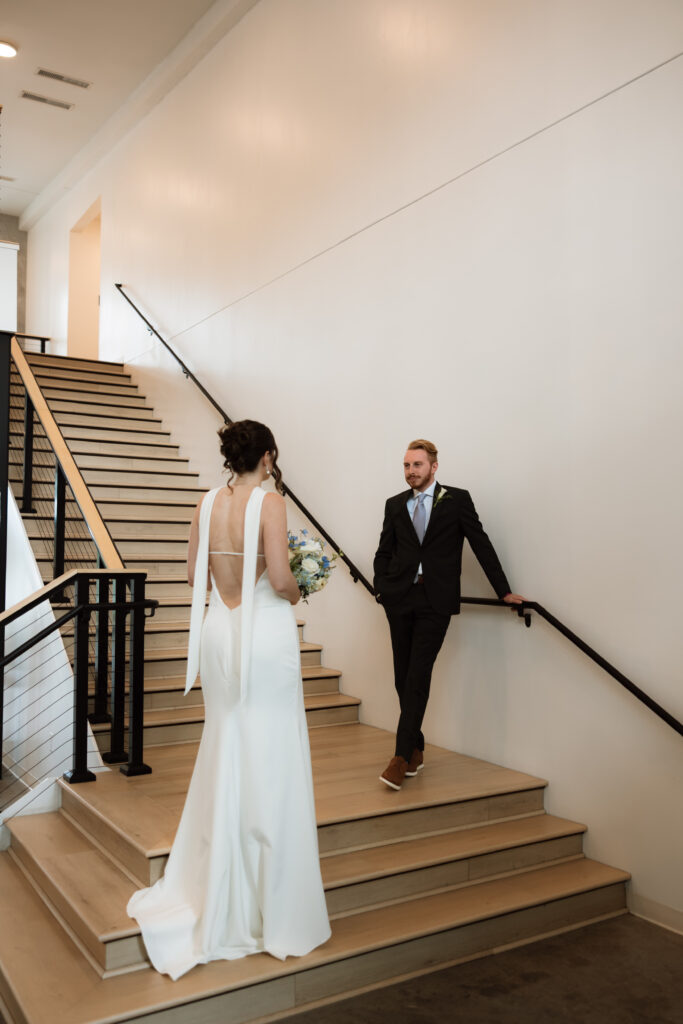 Bride and groom do an editorial pose on the stairs at Catalyst by Nature Link.