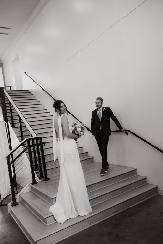 Bride and groom pose on the staircase in Nisswa, Minnesota.
