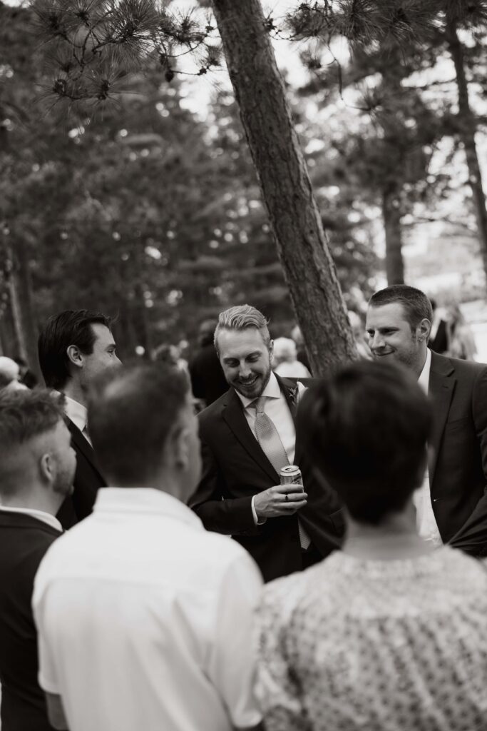 Groom talking with the wedding guests during cocktail hour.
