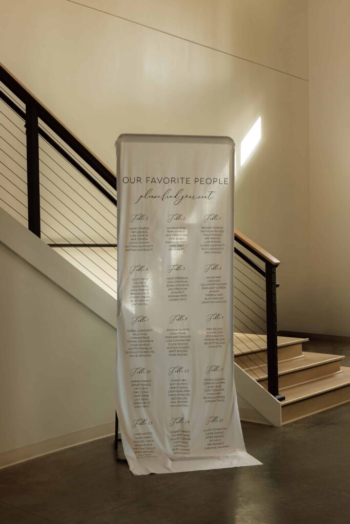 Seating chart linen sign with golden light streaming on it at Catalyst.